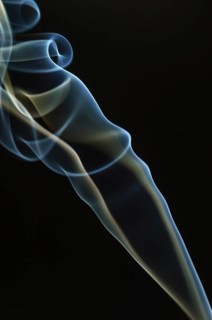 Trajectory of incense smoke in the air showing different shapes. France
