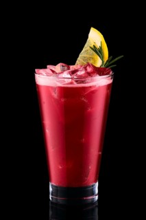 Cold fizz cocktail with cherry isolated on black background
