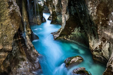 Mountain river Soca flows through narrow canyon