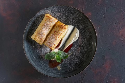 Thin pancakes with curd and sour cream