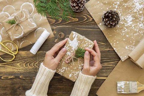Top view hands holding christmas gift with plant pine cones. Resolution and high quality beautiful photo