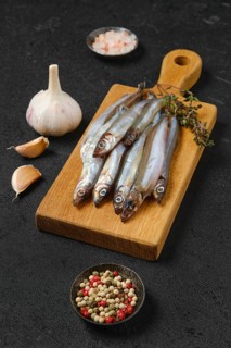 Pile of fresh raw frozen capelin