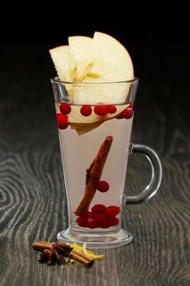 Glass of hot fruit tea with apple
