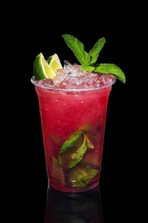 Cold lime and raspberries cocktail with a sparkling wine with ice in take away glass isolated on black