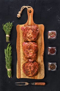 Top view of marinated lamb neck with seasoning and herbs