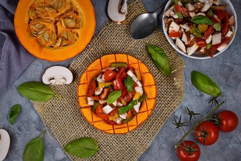 Top view of vegan baked Red Hokkaido squash vegetable filled with bell pepper