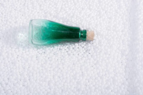 Empty bottle on little white polystyrene foam balls