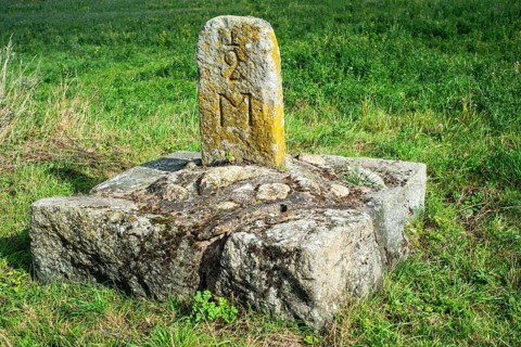 Old milestone on a country road at Roeddinge