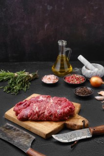 Fresh lamb boneless neck meat on cutting board ready for cooking