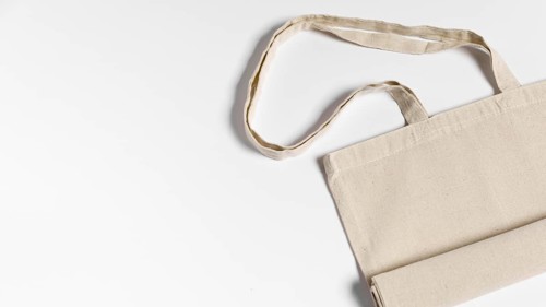 Folded fabric tote bag flat lay