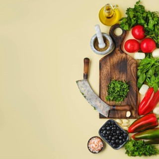 Top view of mezzaluna and ffresh vegetables. World vegan food day concept