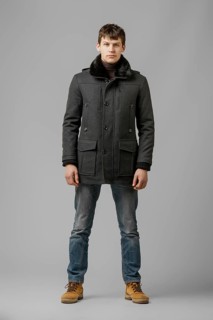 Full length portrait of handsome man in warm winter coat posing in studio