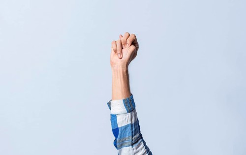 Hand gesturing the letter N in sign language on an isolated background. Man's hand gesturing the letter N of the alphabet isolated. Letter N of the alphabet in sign language