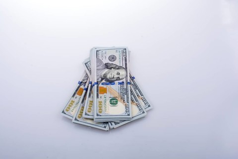 American 100 dollar banknote bundles placed on white background