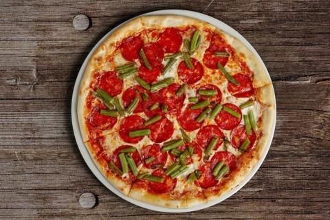 Top view of pizza pepperoni on wooden background