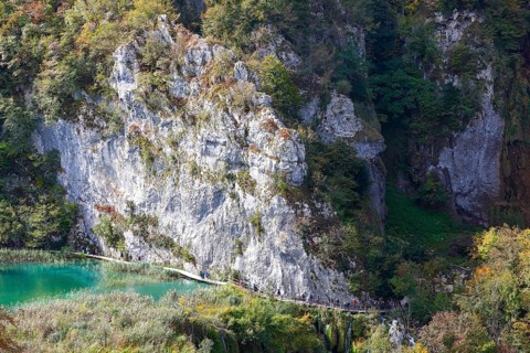 Hikers on wooden footbridge in Plitvice Lakes National Park