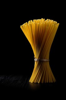 Low key photo of whole wheat ziti pasta. Organic tube spaghetti