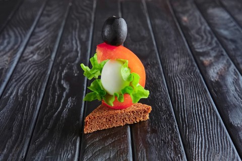 Appetizer for reception. Brown bread with quail egg