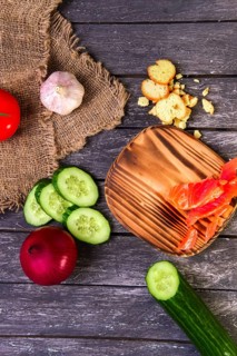 Fresh vegetables on wooden board with a napkin on a table