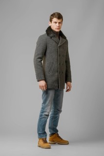Full length portrait of handsome man in warm woolen coat posing in studio
