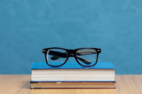 Front view books with glasses
