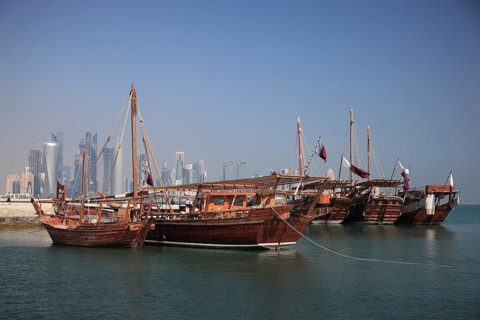 Fishing boats in front of the skyline of Doha