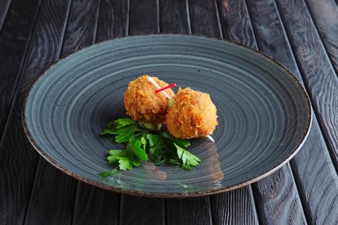 Appetizer for reception. Fried mozzarella balls rolled in bacon in breading
