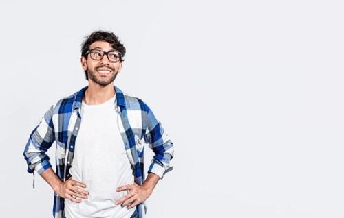 Thoughtful smiling person looking at a blank space. Smiling handsome man looking at an advertisement to the side. smiling man thinking and seeing a blank space
