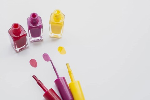 High angle decoration with nail polishes white background