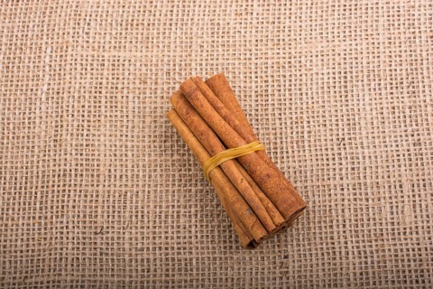 Bundle of cinnamon sticks on a linen canvas background
