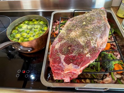 Raw leg of lamb in a roaster with vegetables and spices. Hesse