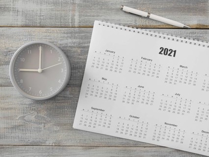 Flat lay desk calendar and analog clock