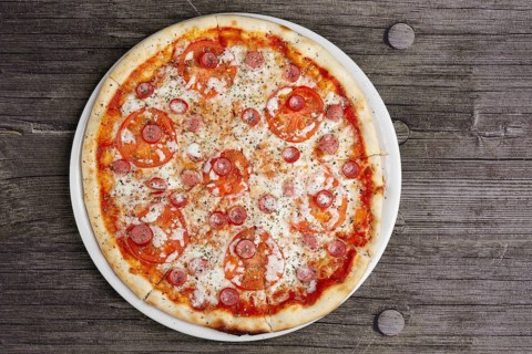 Pepperoni pizza on wooden table