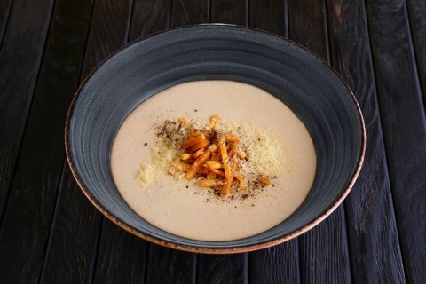 Mushroom soup puree with bacon flakes
