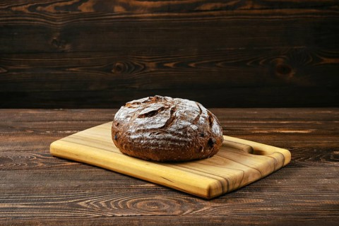 Fresh rye brown bread on wooden cutting board