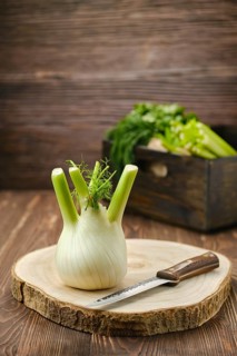 Fresh fennel bulb on wooden cutting board