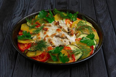 Meat with cheese and slices of potato