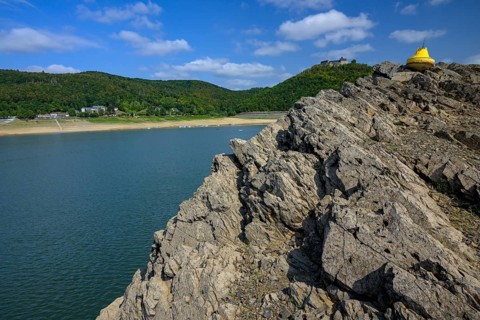 Dry buoy at low water in front of Waldeck Castle in Lake Edersee