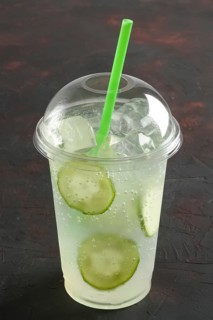 Fresh cold cucumber ice drink in take away plastic glass with straw