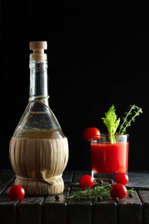 Rustic cocktail Bloody Mary with ingredient on wooden table