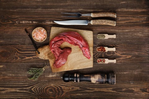 Overhead view of raw fresh top round beef strip with spices