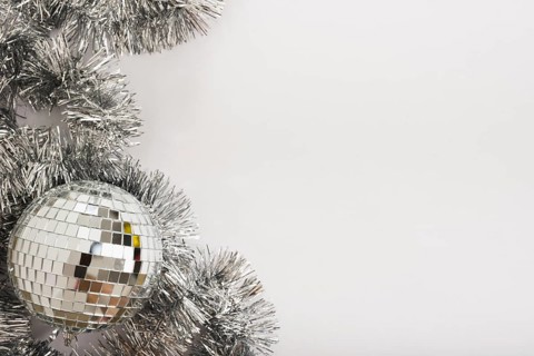 Disco ball with tinsel on white table