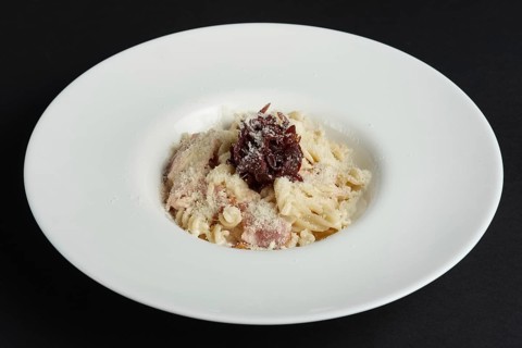 Plate of pasta with salmon and onion marmalade