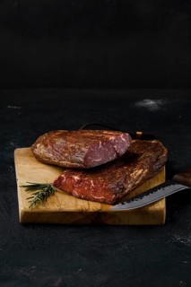 Smoked beef striploin meat on cutting board