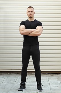 Full length portrait of Fitness instructor with arms crossed