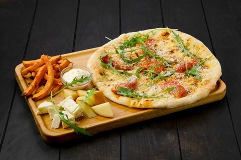 Focaccia with tomato and parmesan served with cheese and fried sweet potato on wooden tray