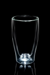 Empty double walled coffee glass isolated on black