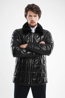 Brutal handsome unshaven man with beard and moustache in waterproof coat with fur collar