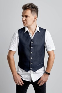 Portrait of trendy man in white shirt and vest looking to the right