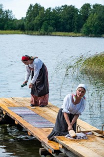 Traditionla dressed women doing hand washing